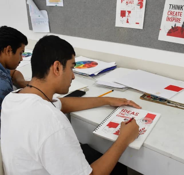 Visual Communication students developing poster concepts in the design studio