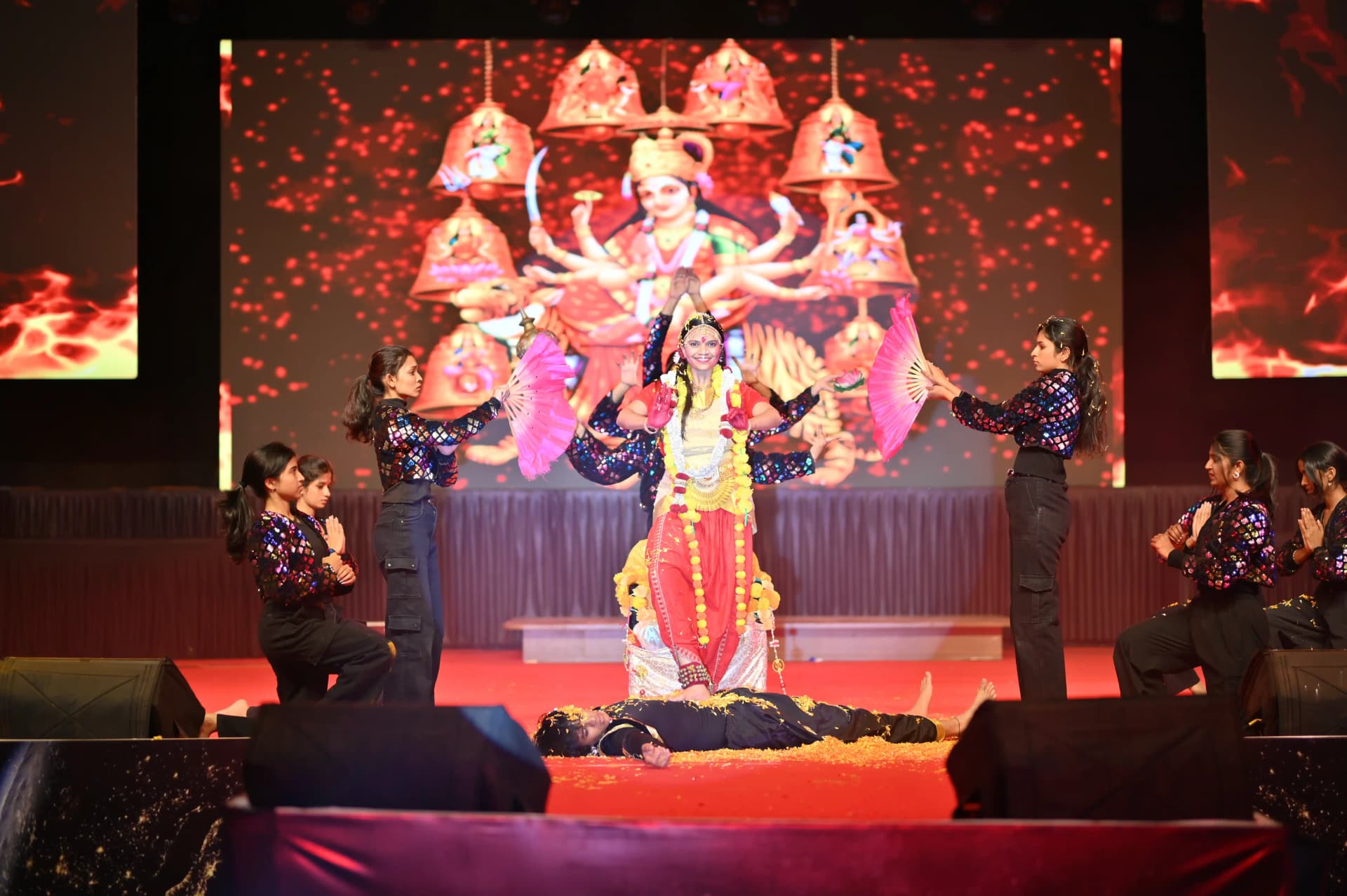 Students celebrating on stage at a PCU festival event