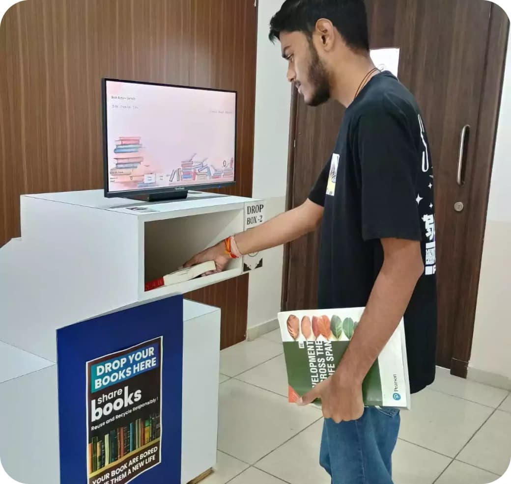 Student using library digital book return and access kiosk