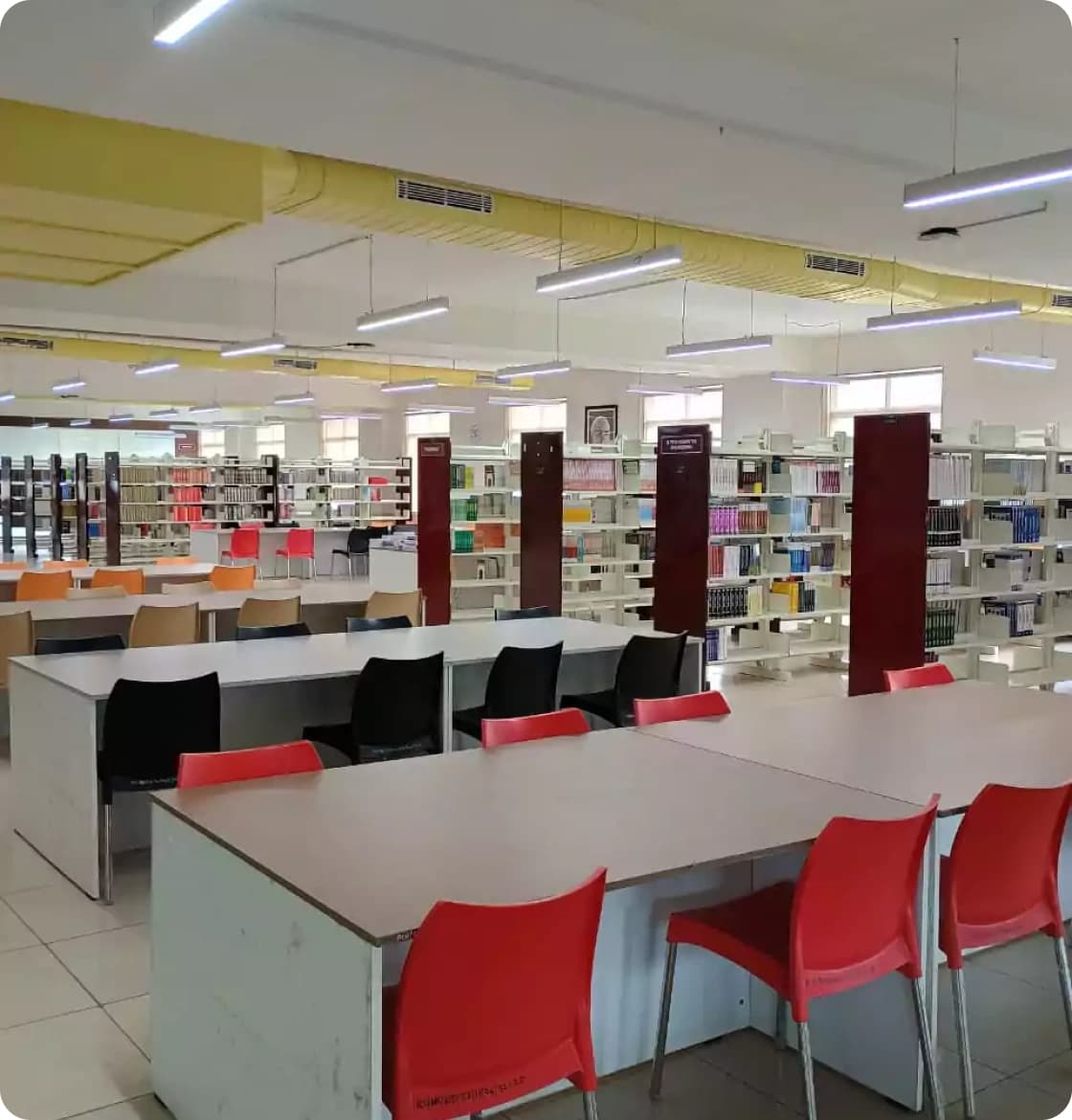 Library reading area with bookshelves and study tables
