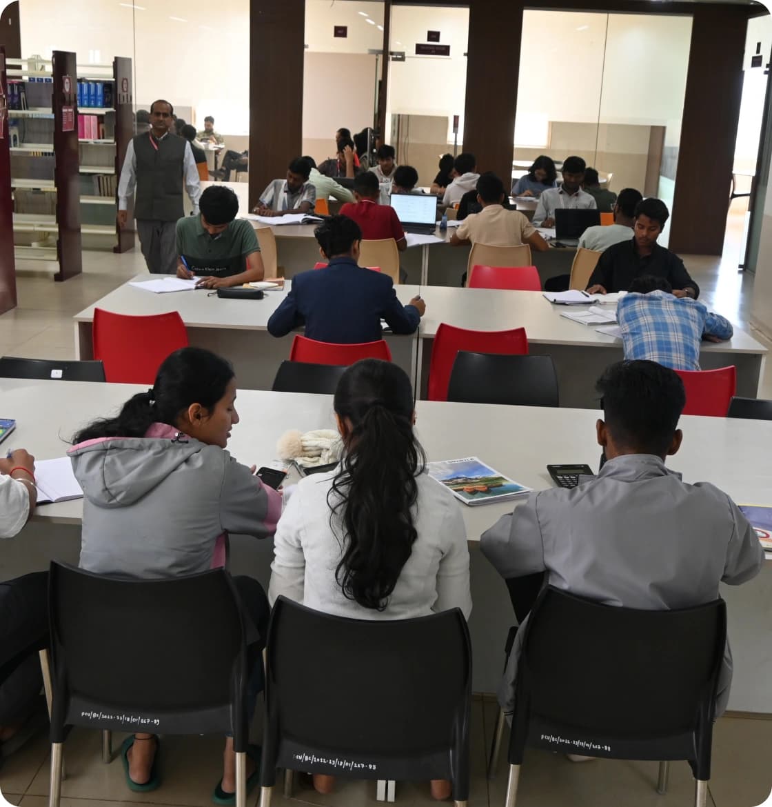 Students studying at tables in the Swami Vivekananda Library