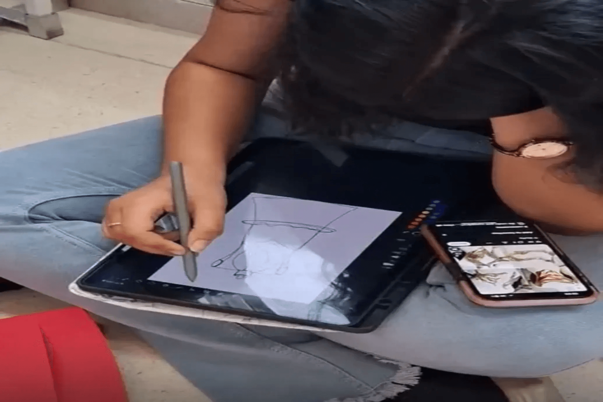 Student sketching on a digital tablet