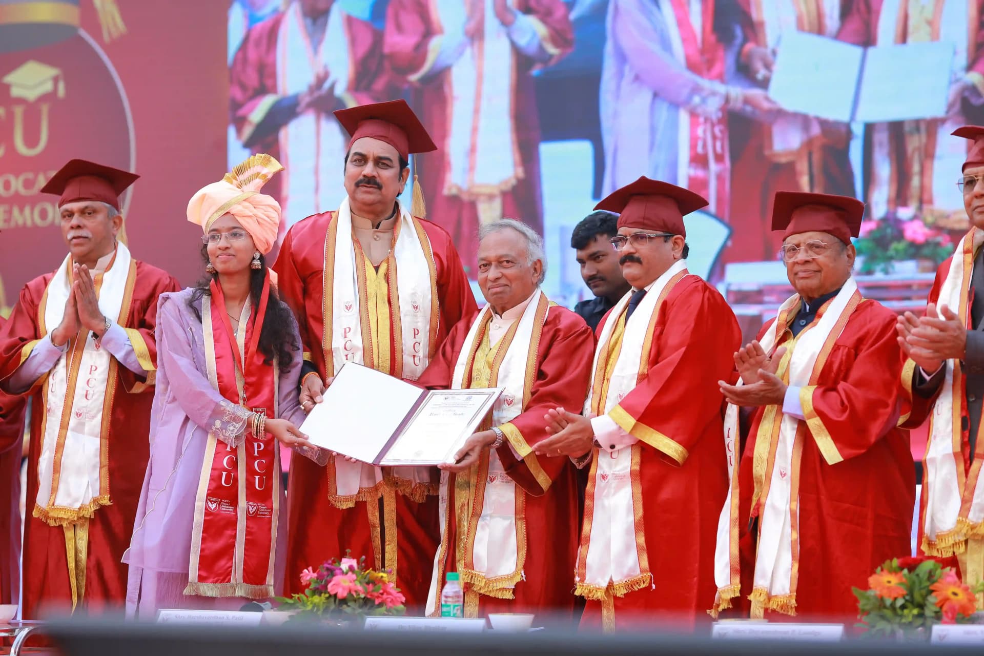 Students receiving degrees on stage