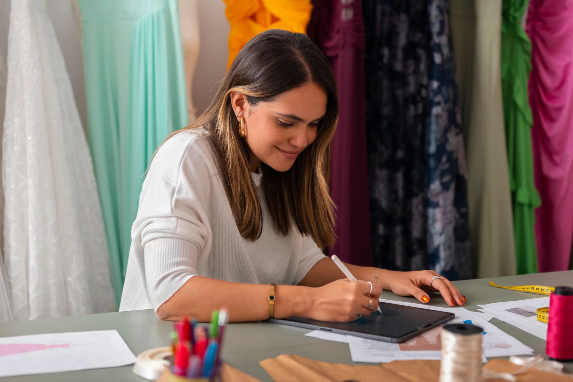 Design student sketching on a digital tablet in the studio