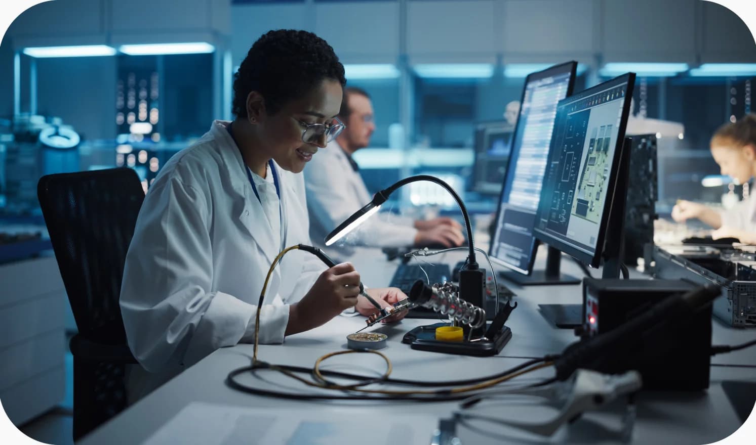 Research engineer working with electronics testing equipment in a lab